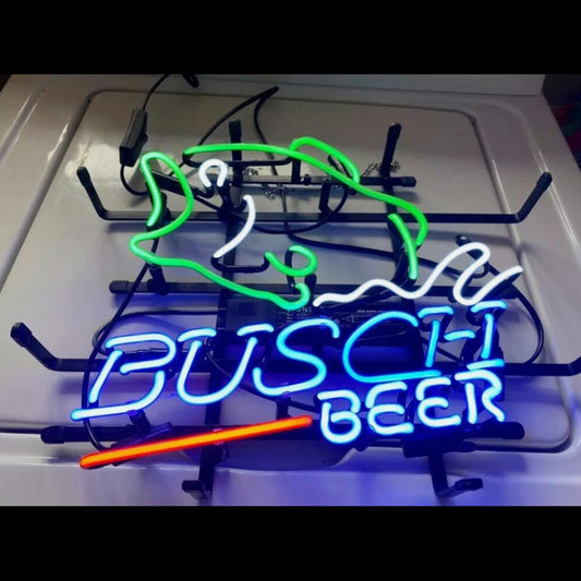 "Vintage-style bass fish silhouette with glowing beer font neon lettering in blue/amber glass tubes, ideal for sports bar decor."