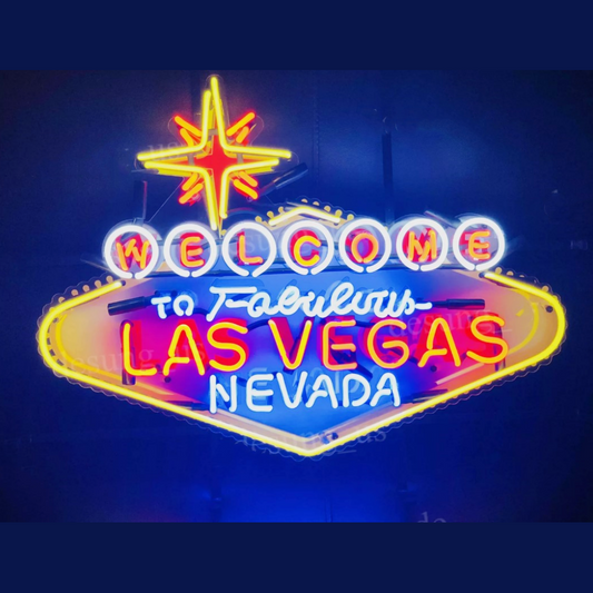 "Vintage Las Vegas neon sign with classic cursive script and blue/red/yellow glass glow, ideal for casino-themed decor and retro collectors。"