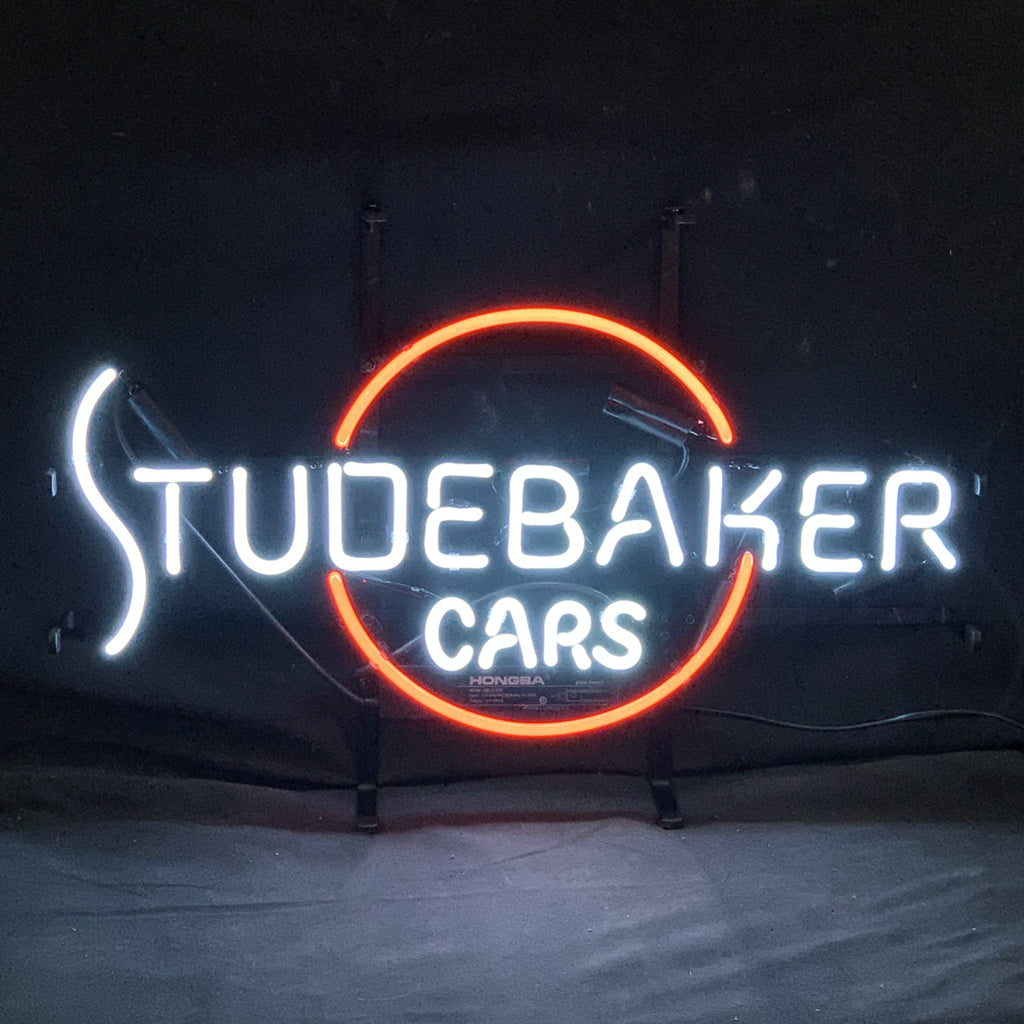 "Studebaker cars neon signs glass - a nostalgic addition to garages, workshops, and automotive spaces."